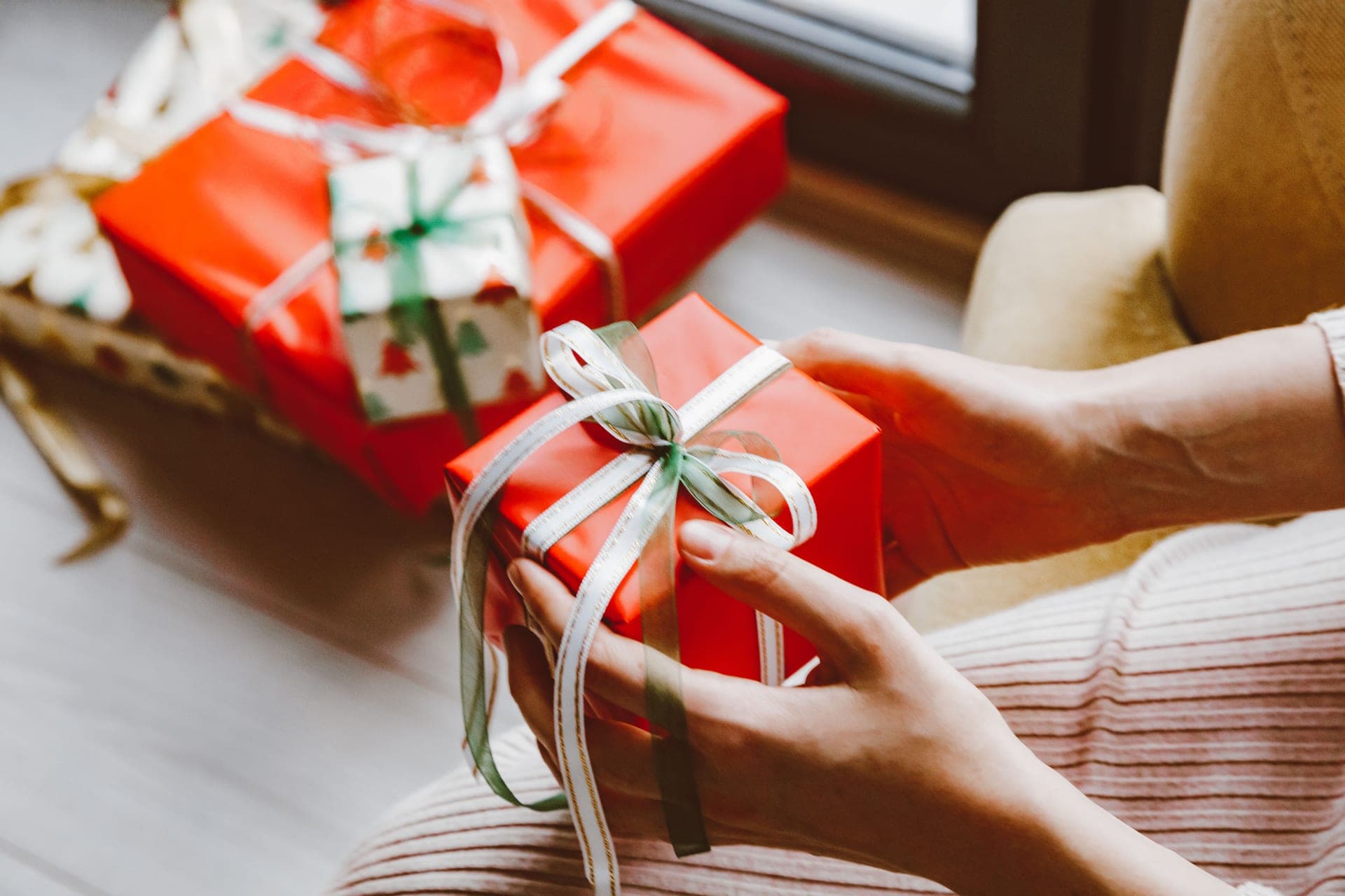 A wrapped Christmas gift box with ribbon in winter