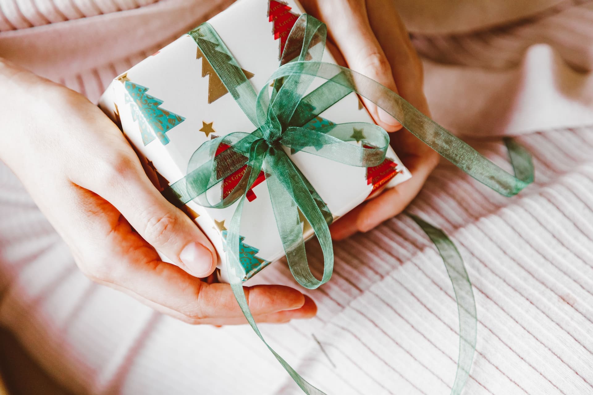 Hands passing a wrapped present